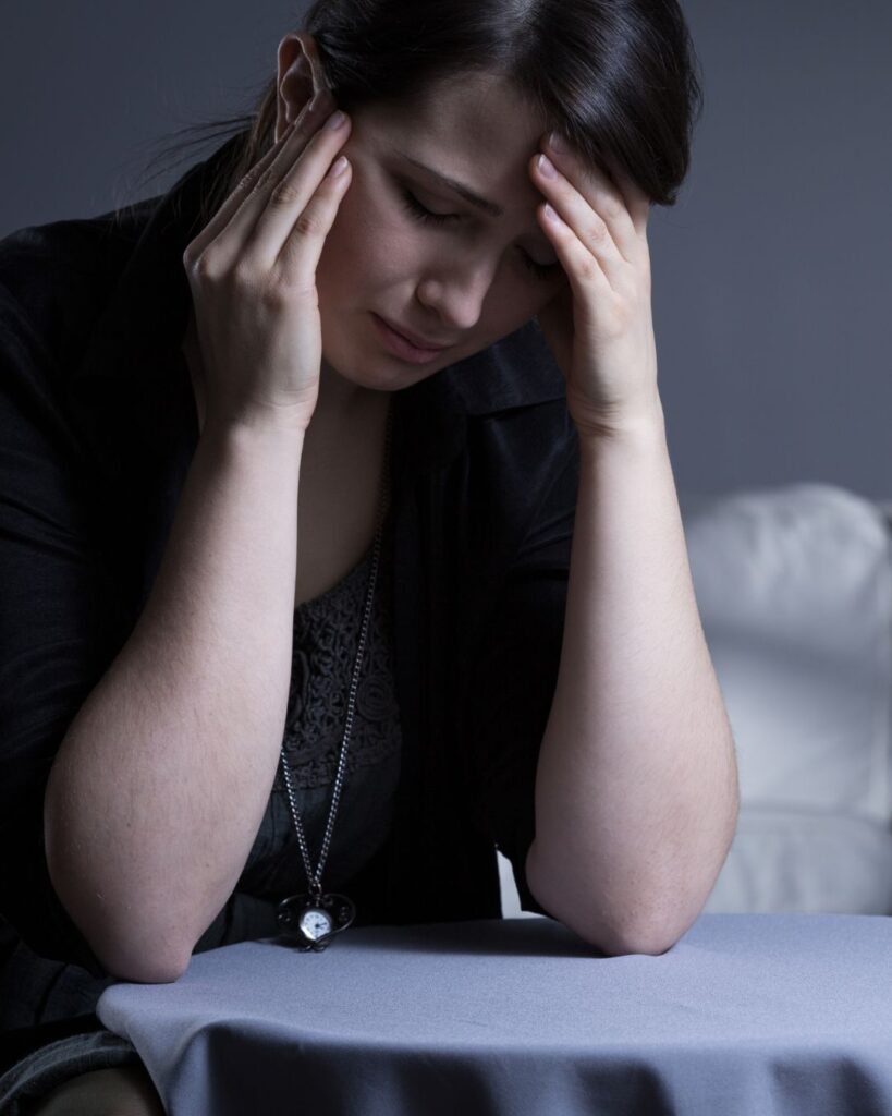 Woman looking sad and distressed after the discovery of betrayal